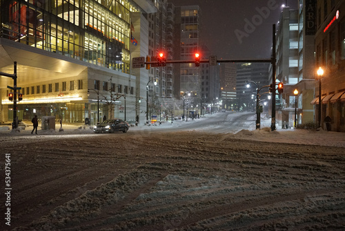 Snow fall in Silver spring (Maruland) during the night: empty avenue and red light