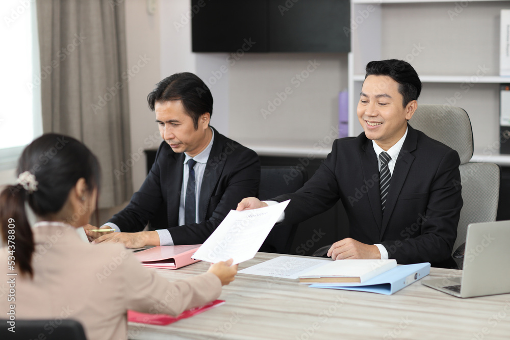 Human resources department managers sitting and interviewing female businesswoman applicant or candidate during job interview in modern office. Business recruitment concept Human resources department managers sitting and interviewing female businesswoman applicant or candidate during job interview in modern office. Business recruitment concept