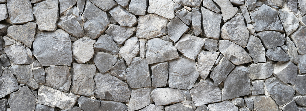 Obraz premium Nature Stone wall texture for background and wallpaper. Abstract rough wall pattern panoramic dimensions.