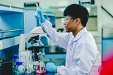  Asian male medical or scientific researcher or doctor Working in The Laboratory.Advanced Scientific Lab for Medicine, Biotechnology, Microbiology Development