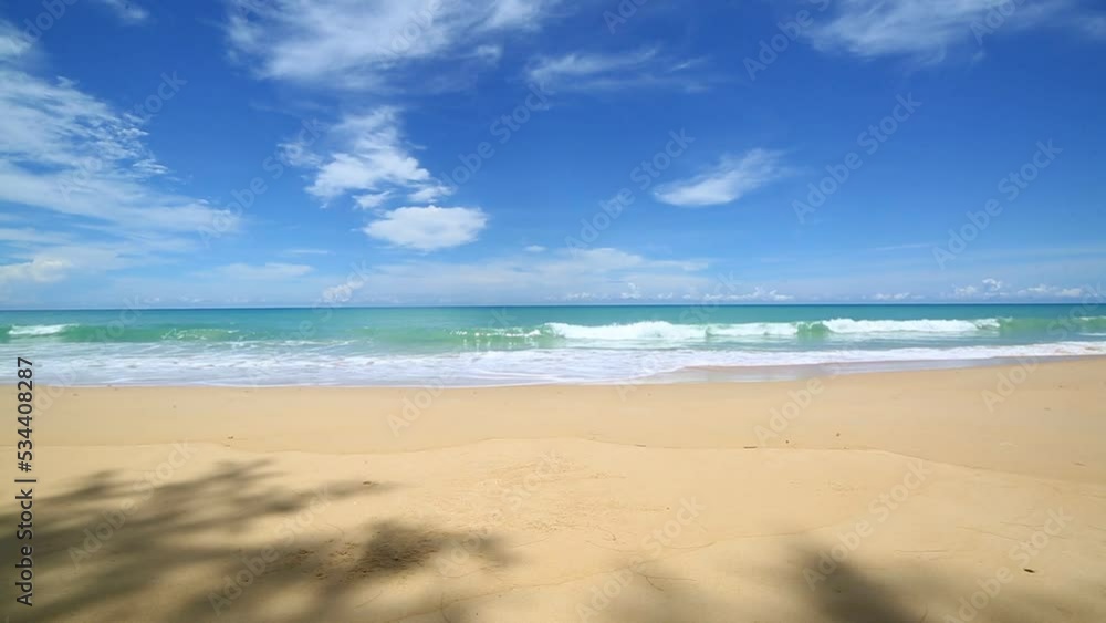 scenery smooth waves from green sea hit on the white long beach..beautiful nature on the beach..white cloud in blue sky background. scenery smooth waves from green sea hit on the white long beach..beautiful nature on the beach..white cloud in blue sky background.