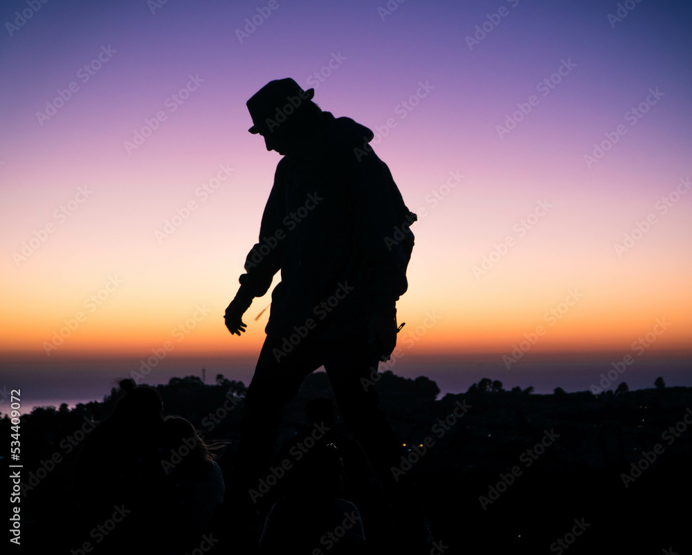 Silhouette of man dancing at dusk in San Francisco Twin Peaks 1