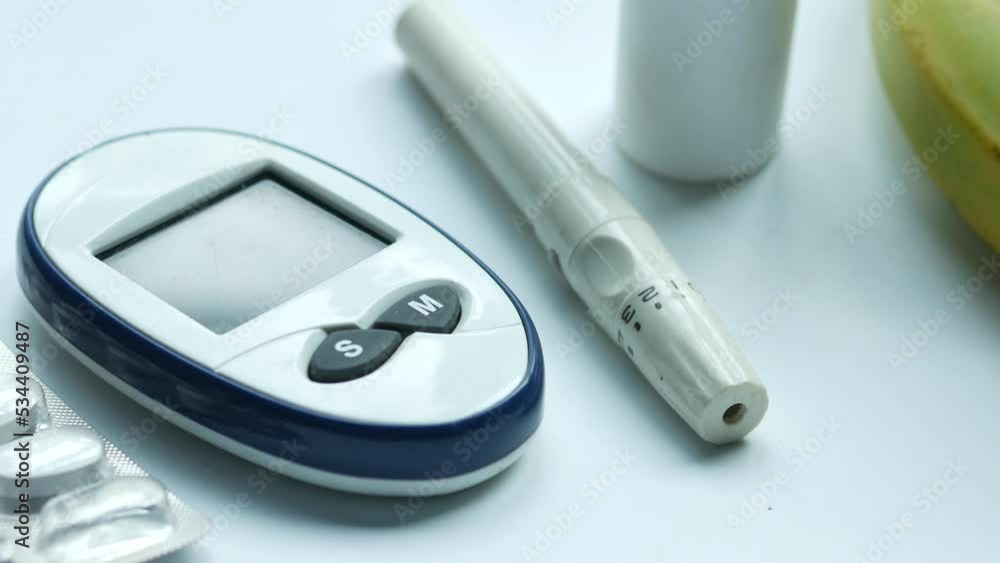 Close up of diabetic measurement tools and pills on white background Close up of diabetic measurement tools and pills on white background