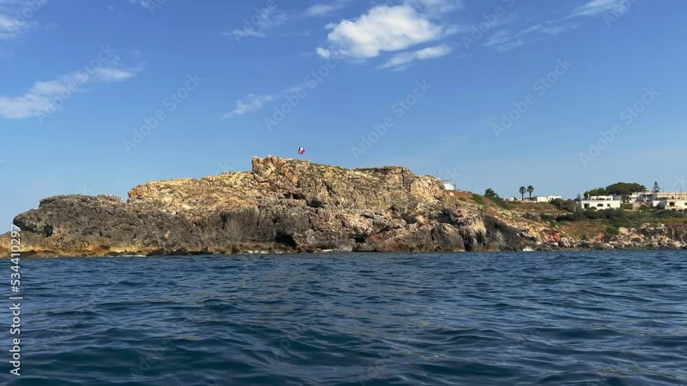 Tour boat at southernmost rock of Italy on Ionian coast of Salento in Apulia. Low angle water surface fpv pov Tour boat at southernmost rock of Italy on Ionian coast of Salento in Apulia. Low angle water surface fpv pov