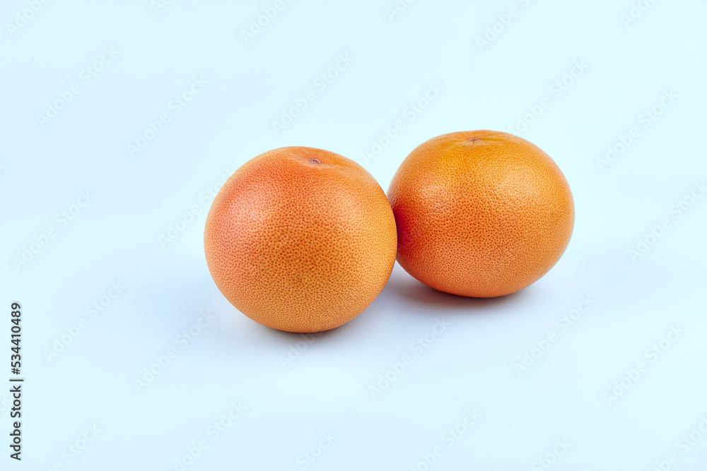 Two grapefruits on a white background in close-up. Two grapefruits on a white background in close-up.
