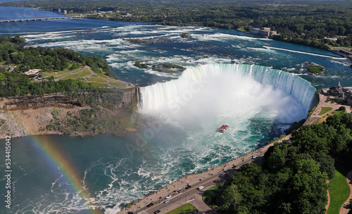 Aerial view of Horseshoe Falls including Hornblower Boat sailing and rainbow on Niagara River, Canada and USA natural border photo