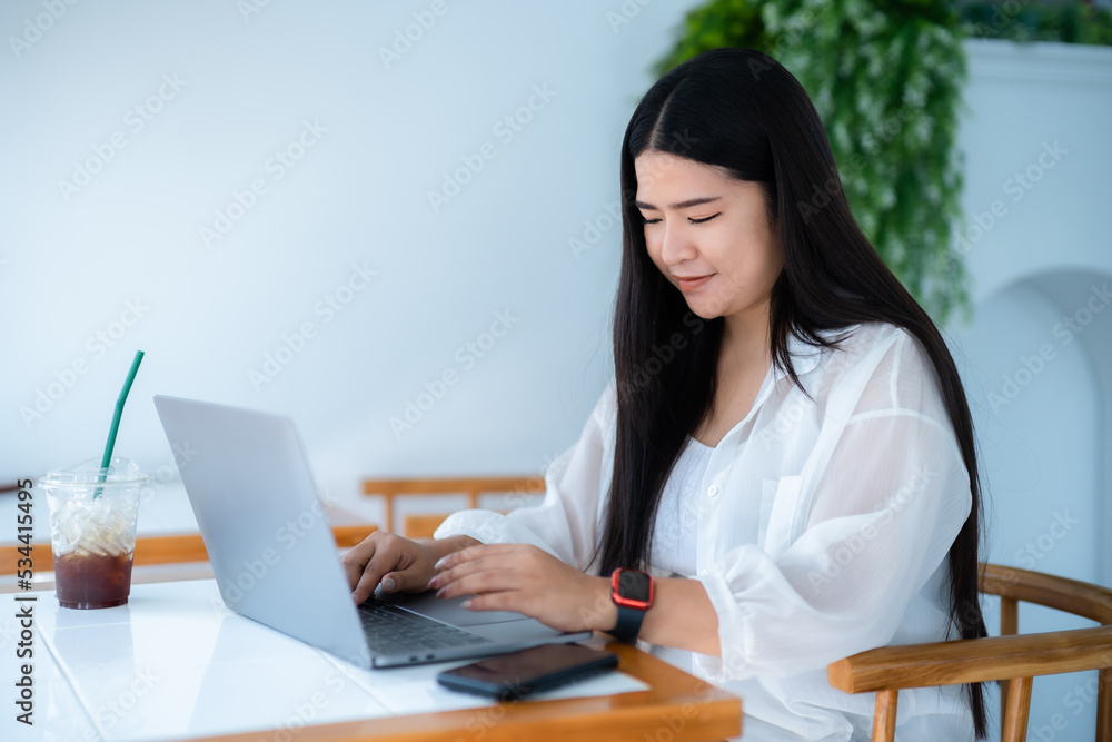 asian freelance people business female wearing smartwatch talking making using casual working with laptop computer for browsing internet, chatting and blogging and smartphone,notebook in coffee shop. asian freelance people business female wearing smartwatch talking making using casual working with laptop computer for browsing internet, chatting and blogging and smartphone,notebook in coffee shop.