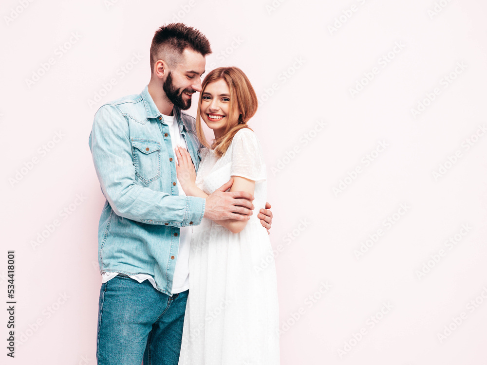 smiling beautiful woman and her handsome boyfriend. Happy cheerful family having tender moments near wall in studio. Pure cheerful models hugging. Embracing each other. Cheerful and happy smiling beautiful woman and her handsome boyfriend. Happy cheerful family having tender moments near wall in studio. Pure cheerful models hugging. Embracing each other. Cheerful and happy