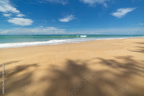 scenery white cloud in blue sky above long white beach..beautiful nature on the beach..smooth waves from green sea background.