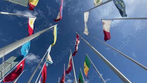 Flags of the World waving in the wind on a background blue sky and white clouds. flags of many countries.  for political, international trade, relationship concepts