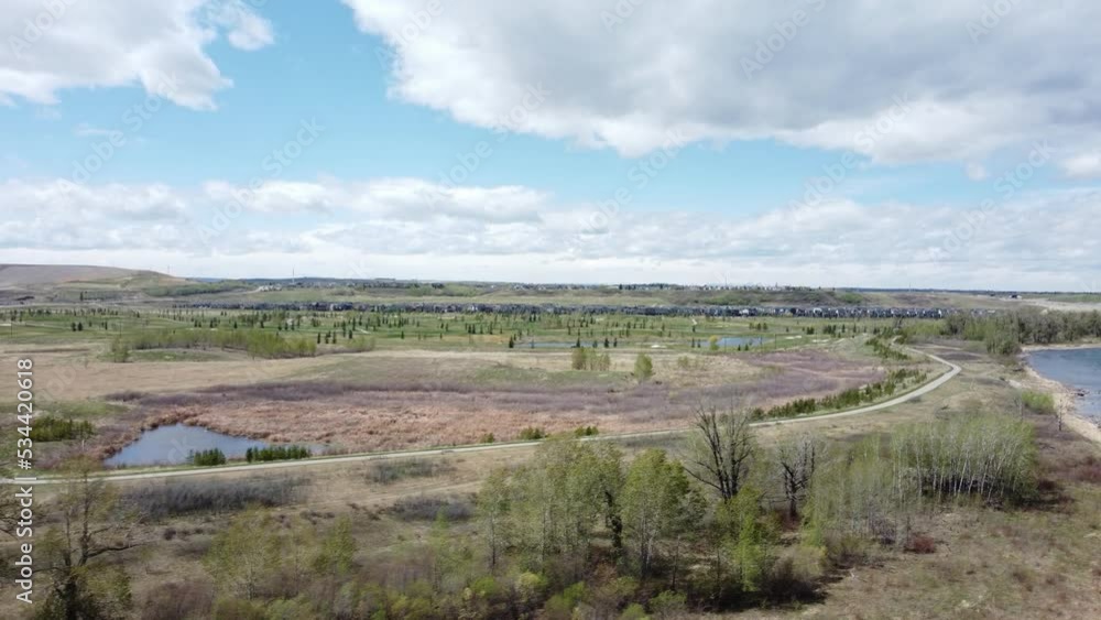 Bike path in city park along with river and golf course and hills on background Bike path in city park along with river and golf course and hills on background