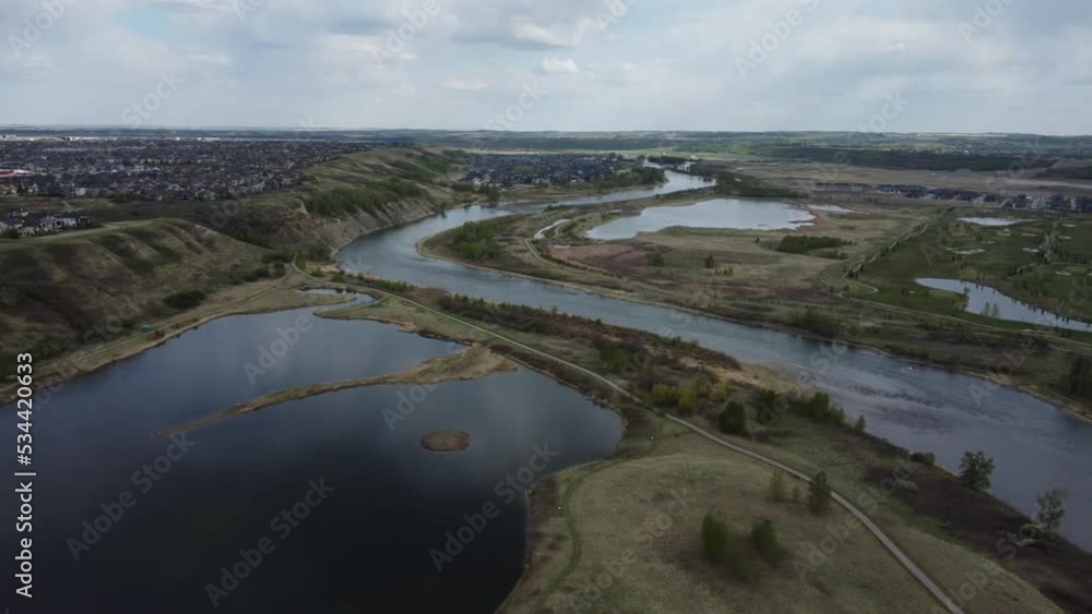 Hilly residential area surrounded with ponds and bike path. Cloudy weather. Hilly residential area surrounded with ponds and bike path. Cloudy weather.