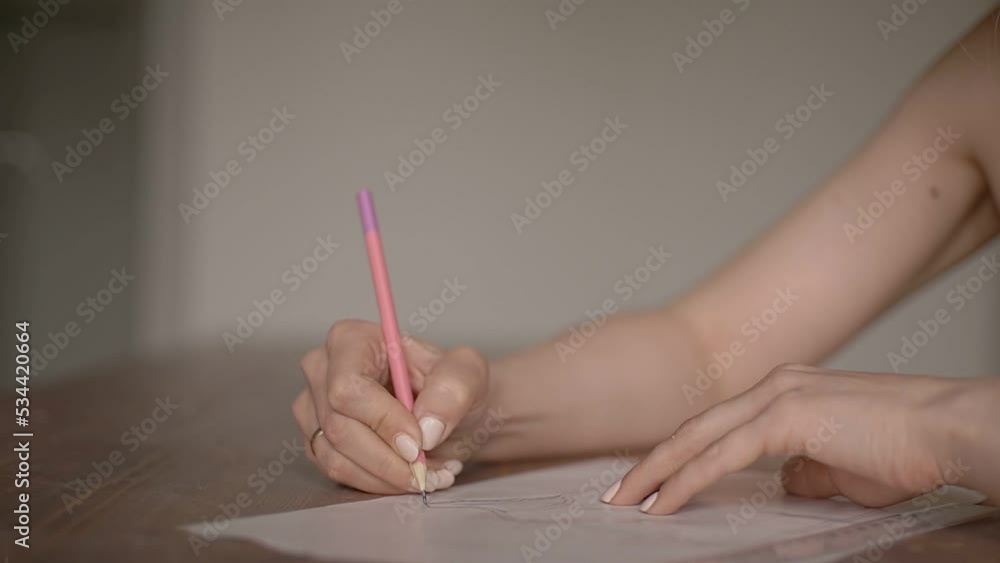 girl draws with a pink pencil girl draws with a pink pencil