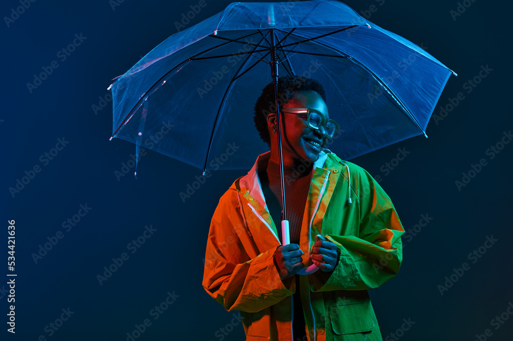 Hipster woman in raincoat with umbrella in neon light Stock-Foto | Adobe  Stock