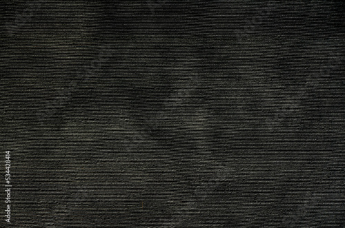Striped sand concrete wall texture background. Close-up of black cement plasterer pattern.