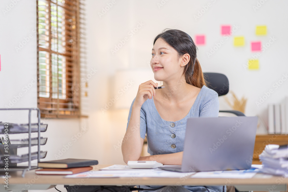 Young business Asian woman working at desk with laptop computer in home office, Tax Accountant Young Asian woman Doing Sales Invoice Accounting. Young business Asian woman working at desk with laptop computer in home office, Tax Accountant Young Asian woman Doing Sales Invoice Accounting.