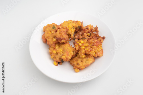 close up of fried corn fritter or in Indonesia called Perkedel Jagung or Bakwan Jagung with shrimp inside isolated on white background