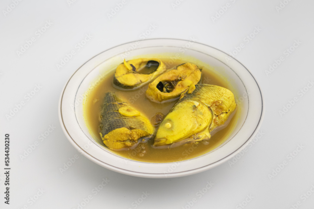milkfish cooked with yellow sour soup on white plate isolated on white background milkfish cooked with yellow sour soup on white plate isolated on white background