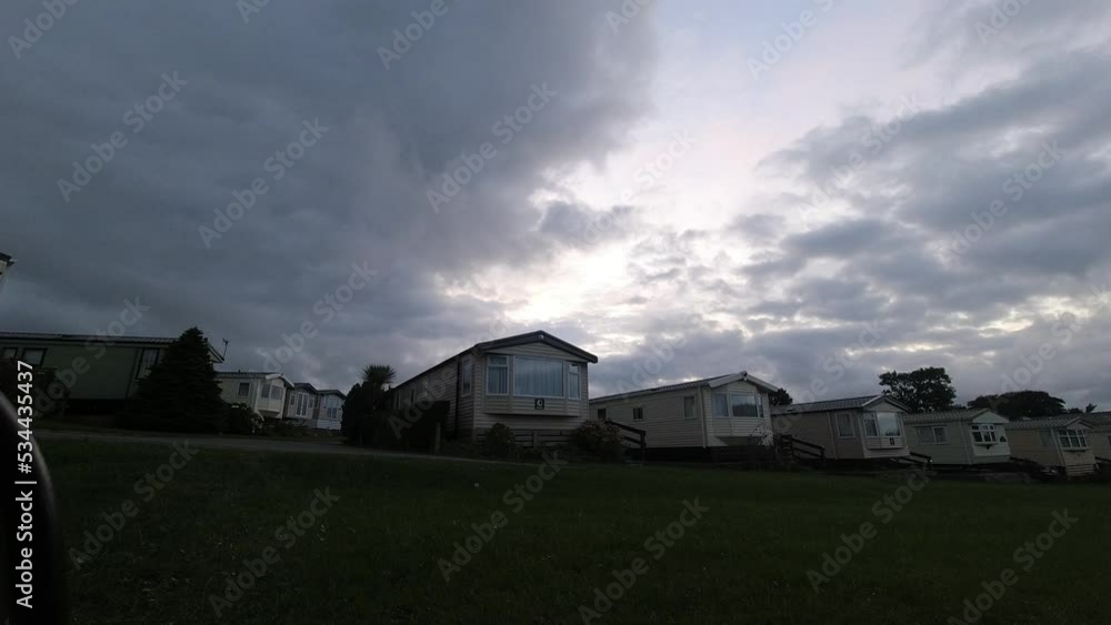 Climate change storm clouds time lapse over static caravan holiday homes UK Climate change storm clouds time lapse over static caravan holiday homes UK