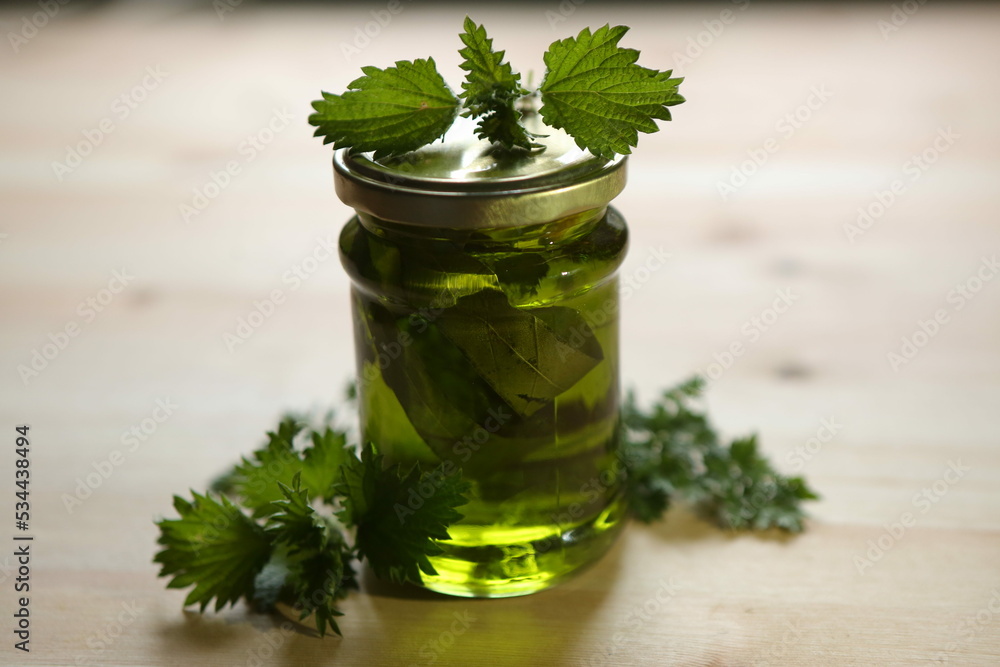 Green eucalyptus jam stands on a wooden table surface Green eucalyptus jam stands on a wooden table surface