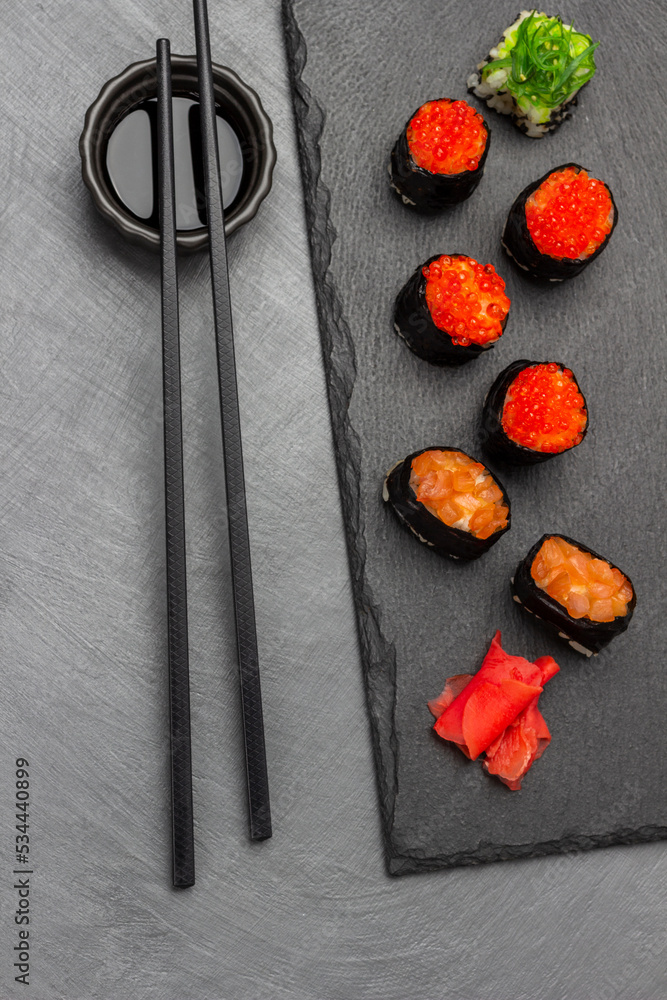Sushi with caviar and salmon on stone board. Sushi with caviar and salmon on stone board.