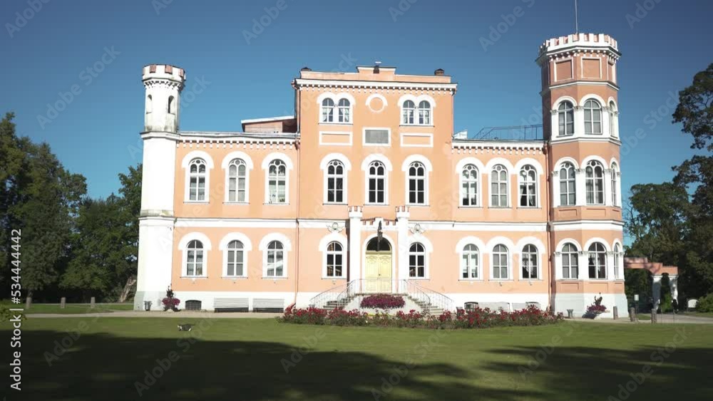 Birinu Palace, Latvian Castle by Lake With Nice Garden. Birini Manor, Vidzeme Region, Latvia. Stedicam Shot Autumn Sunny Day. Camera Moves Forward Birinu Palace, Latvian Castle by Lake With Nice Garden. Birini Manor, Vidzeme Region, Latvia. Stedicam Shot Autumn Sunny Day. Camera Moves Forward