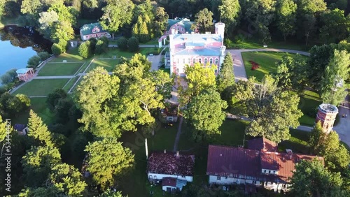 Aerial View of the Birinu Palace. Latvian Castle by Lake With Nice Garden, Drone Shot. Birini Manor, Vidzeme Region, Latvia Autumn Sunny Day. Camera Moves Forward photo