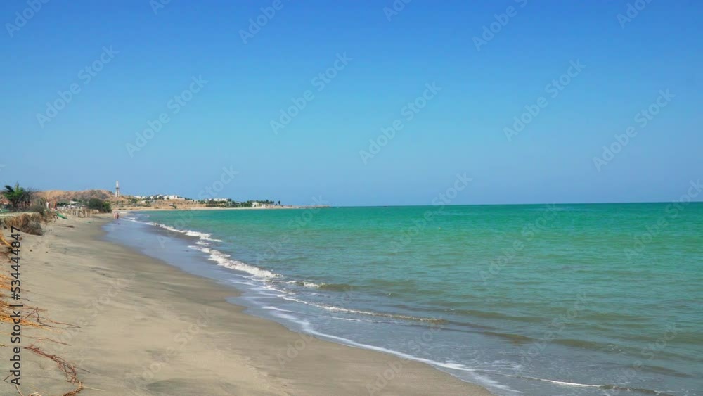The tides of the blue and green emerald sea are coming to the shores of the yellow sands of Zorritos beach in Tumbes, Peru. The tides of the blue and green emerald sea are coming to the shores of the yellow sands of Zorritos beach in Tumbes, Peru.