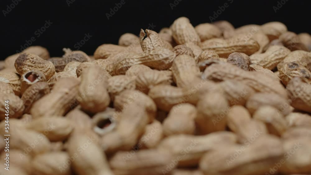Spinning wide angle of a pile of peanuts with a black background. Spinning wide angle of a pile of peanuts with a black background.