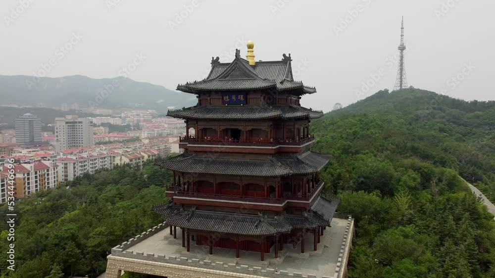 custom made wallpaper toronto digitalAerial cinematic right-hand orbit of the Huancui lou pagoda in Weihai city, China.
