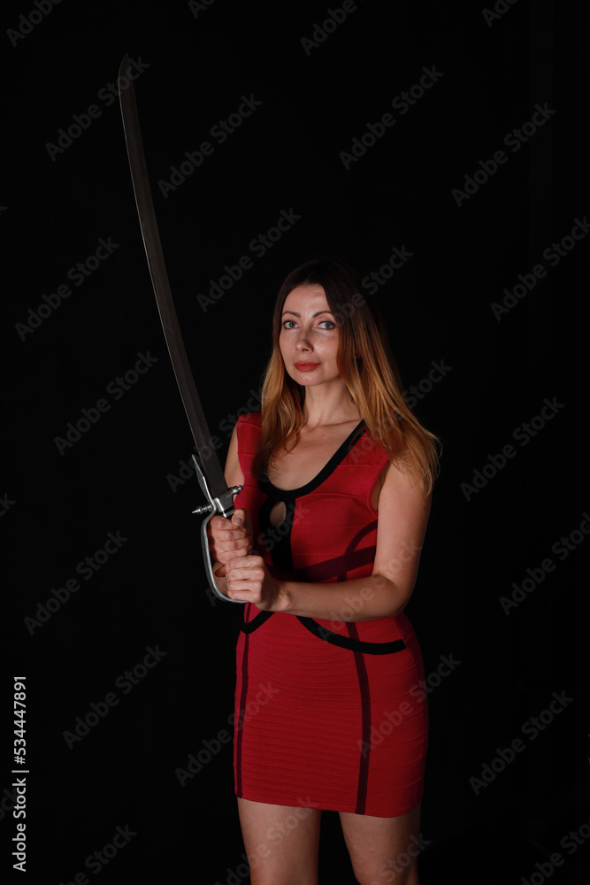 Woman in red dress with vintage sword