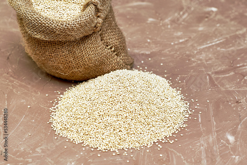 quinoa groats in a canvas bag on the table photo