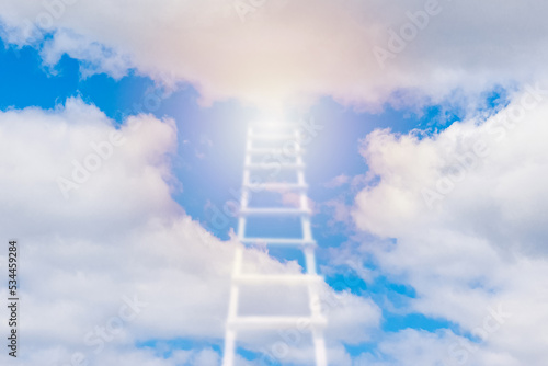 Beautiful religious background.Sunset or sunrise with clouds blurred stairs to heaven bright light from heaven stairway leading up to skies clouds.Light from sky.Religion concept.Blurred soft focus.
