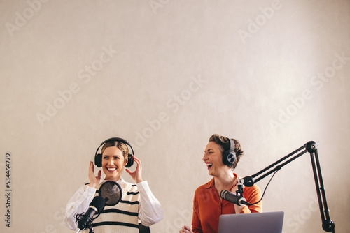 Female radio presenters having a good time on a live broadcast photo