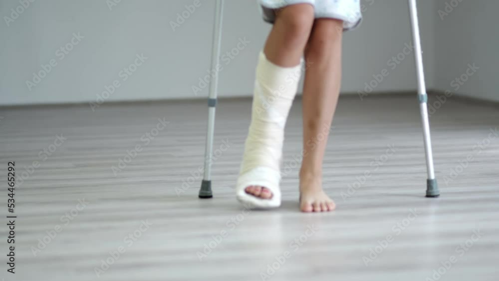 Woman with broken leg Using Crutches For Walking, selective focus Woman with broken leg Using Crutches For Walking, selective focus