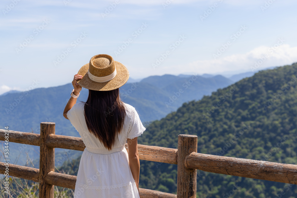 Travel woman stand on the top and look at the mountain