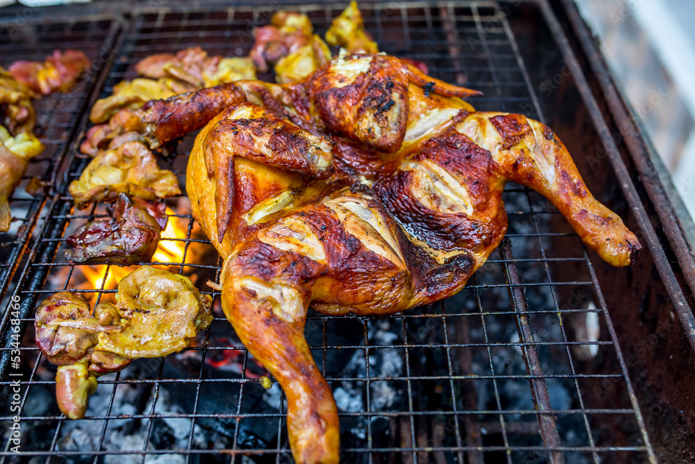 Delicious chicken wings and lamb barbecue on hot grill