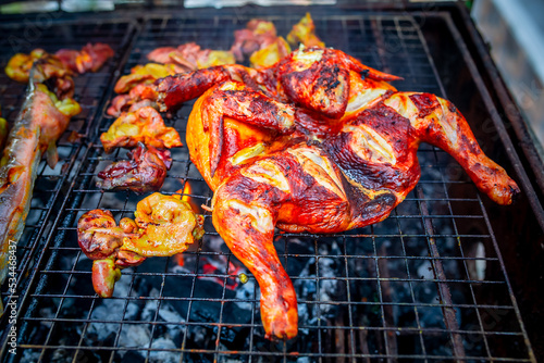 Delicious chicken wings and lamb barbecue on hot grill