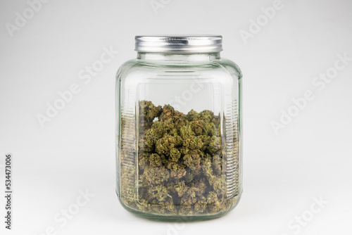 Glas Jar half filled with Marijuana, Cannabis, Weed, Pot isolated on white background