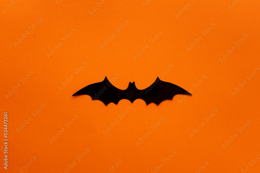 Fototapeta premium orange halloween background with a bat in the middle