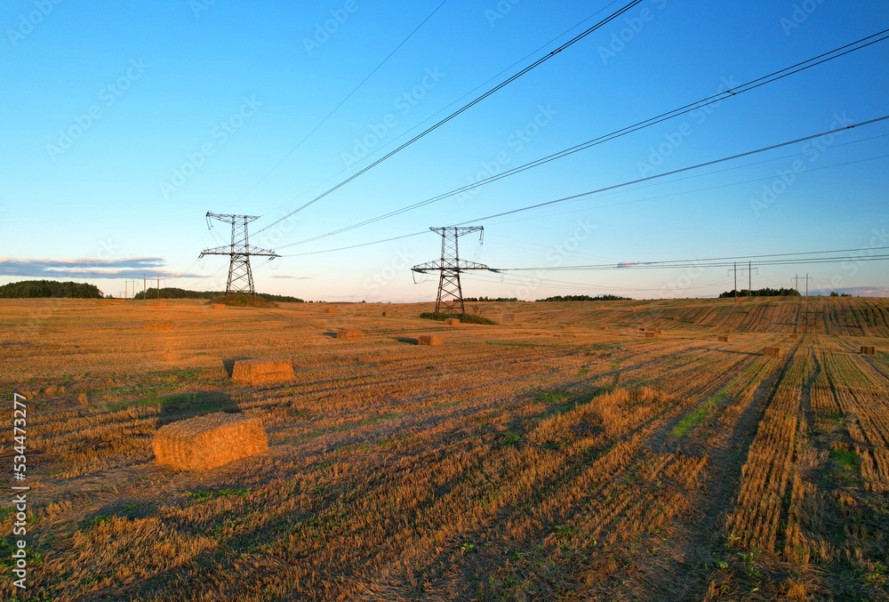 High voltage electricity pylons and transmission power lines in field ...
