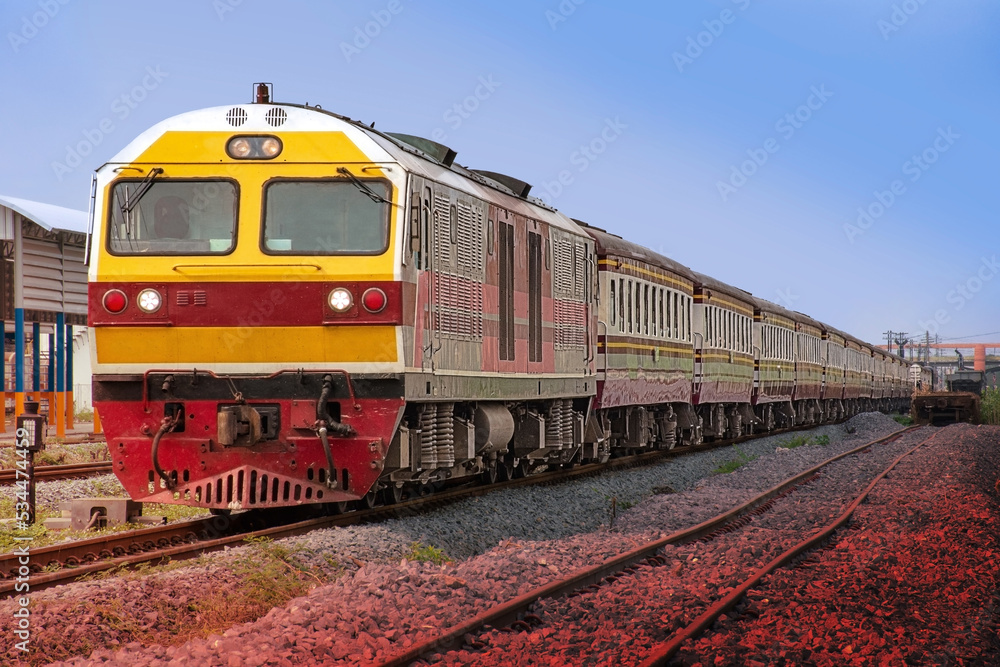 Passenger train by diesel locomotive at the railway station. 