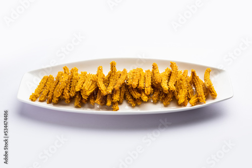 Bhajni chakli sticks or crunchy murukku snack made using diwali festival, favourite munching food photo