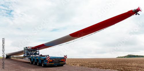 Wind turbine under construction. Blade for wind turbines close up. Special transport of a blade for a wind turbine on a special semi-trailer