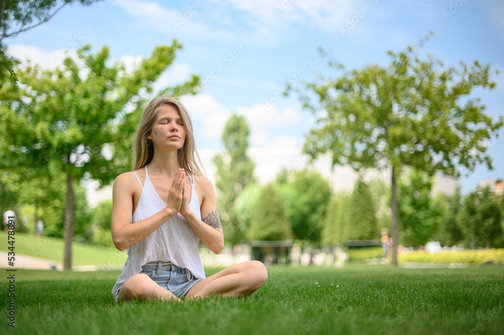 Girl practice yoga meditation outdoor in park