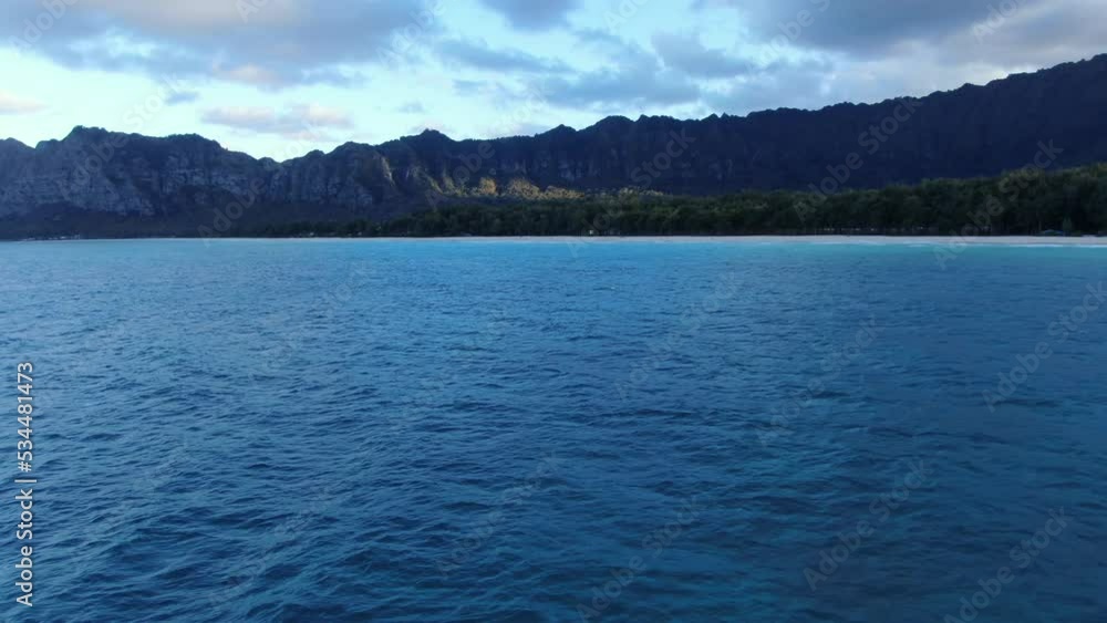 An offshore view of the ocean, forest, and mountains of OAHU. Drone parallax revealing the natural beauty of Hawaii. An offshore view of the ocean, forest, and mountains of OAHU. Drone parallax revealing the natural beauty of Hawaii.