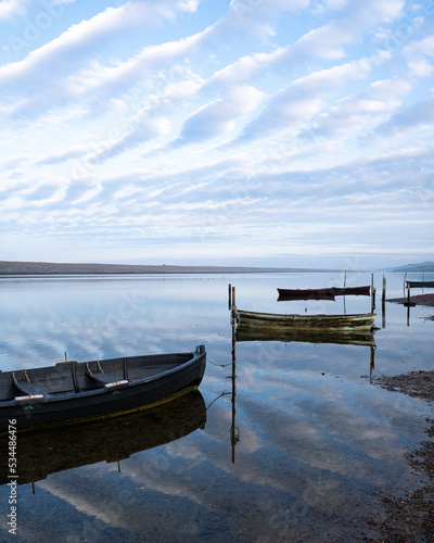 Boats sitting on water reflecting the sky in Dorset
