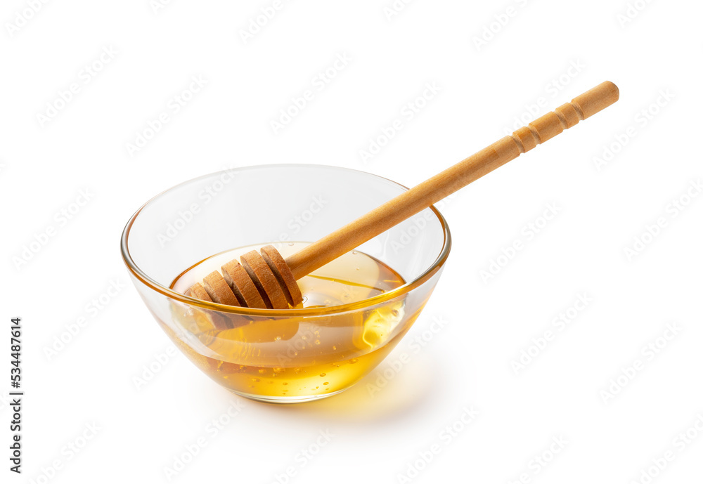 Honey and honey dippers in glass bowls on white background. Honey and honey dippers in glass bowls on white background.