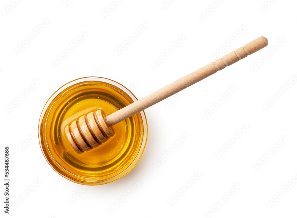 Honey in glass container and wooden honey dipper on white background. Honey in glass container and wooden honey dipper on white background.