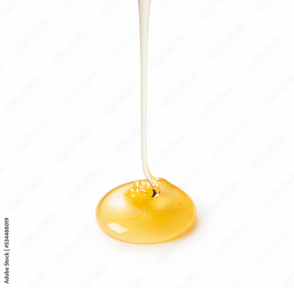 Moment of dripping honey on white background. Moment of dripping honey on white background.